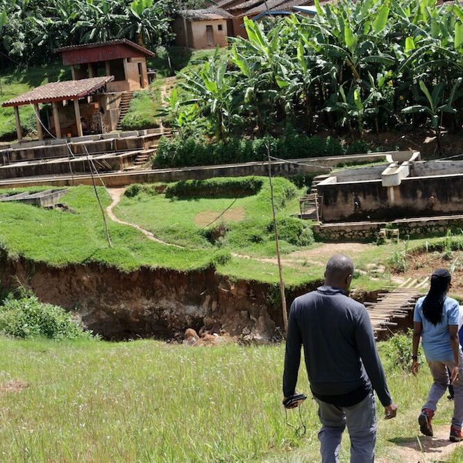 Jeanine, center, walking down hill at Matongo